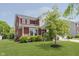 Well-manicured two-story home featuring beautiful landscaping, and attractive exterior details at 11840 Crossbill Ct, Noblesville, IN 46060