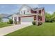 Well-maintained two-story home featuring a two-car garage, manicured lawn, and attractive exterior details at 11840 Crossbill Ct, Noblesville, IN 46060