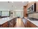 The kitchen has stainless steel appliances, wooden cabinets, granite countertops, and a large island at 11840 Crossbill Ct, Noblesville, IN 46060