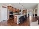 The kitchen is equipped with stainless steel appliances, granite countertops, a large island, and wooden cabinets at 11840 Crossbill Ct, Noblesville, IN 46060