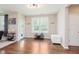 Light-filled living room with hardwood floors, white trim, and natural light from the large windows at 11840 Crossbill Ct, Noblesville, IN 46060