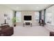 Cozy living room with a fireplace, plush carpeting, large windows and comfortable seating, with natural light at 11840 Crossbill Ct, Noblesville, IN 46060