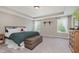 This primary bedroom suite offers ample space with lots of natural light from the surrounding windows at 11840 Crossbill Ct, Noblesville, IN 46060