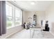 Bright home office with large windows, a cozy sitting area, and a functional workspace at 11840 Crossbill Ct, Noblesville, IN 46060