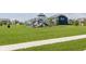 A vibrant community playground features slides and climbing structures amidst lush green lawns and modern homes at 11840 Crossbill Ct, Noblesville, IN 46060