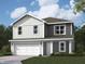Two-story home featuring gray and white siding, a two-car garage, and a well-manicured lawn at 1207 Mcbride St, Greenfield, IN 46140