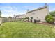 Lush backyard with a well-maintained lawn, privacy fence, and outdoor seating area for relaxation and gatherings at 12259 Sweet Creek Trl, Fishers, IN 46037