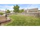 Spacious backyard with lush green grass, a wooden fence, and a charming patio area for outdoor living at 12259 Sweet Creek Trl, Fishers, IN 46037