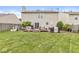 Manicured backyard with a spacious lawn, wooden fence, and a cozy patio area perfect for entertaining at 12259 Sweet Creek Trl, Fishers, IN 46037