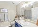 Bright bathroom featuring a modern vanity with gold fixtures, a decorative mirror, and a shower-tub combo at 12259 Sweet Creek Trl, Fishers, IN 46037