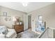Well-lit Bedroom with cozy chair, wooden dresser, and book display, creating a warm and inviting space at 12259 Sweet Creek Trl, Fishers, IN 46037
