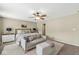Spacious bedroom with ceiling fan, seating area, and stylish decor, perfect for relaxation and comfort at 12259 Sweet Creek Trl, Fishers, IN 46037