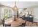 Charming dining room features a round table, pendant lighting and views to the front yard at 12259 Sweet Creek Trl, Fishers, IN 46037
