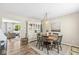 Cozy dining room featuring a round wooden table, stylish hutch, and elegant decor with living area view at 12259 Sweet Creek Trl, Fishers, IN 46037