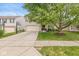 Attractive home with a well-maintained lawn, mature tree, and an ample driveway leading to the garage at 12259 Sweet Creek Trl, Fishers, IN 46037