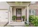 Close-up of the front porch showcasing stylish potted plants, a wreath, and the house number at 12259 Sweet Creek Trl, Fishers, IN 46037