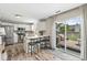 Well-lit kitchen with stainless steel appliances, breakfast bar, and sliding door to outdoor patio at 12259 Sweet Creek Trl, Fishers, IN 46037