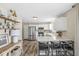 Bright kitchen with white cabinets, stainless steel appliances, and a breakfast bar with seating at 12259 Sweet Creek Trl, Fishers, IN 46037