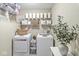 Organized laundry room with modern washer and dryer, shelving, and decorative storage baskets at 12259 Sweet Creek Trl, Fishers, IN 46037