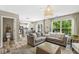Bright, open-concept living room featuring a comfortable sectional sofa and a view into the kitchen at 12259 Sweet Creek Trl, Fishers, IN 46037