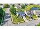 An aerial view showcases this home nestled in a tranquil neighborhood with mature trees and a pond at 12322 Cool Winds W Way, Fishers, IN 46037