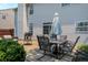 Backyard patio with an outdoor dining set, grill, and a cozy seating area near lush greenery at 12322 Cool Winds W Way, Fishers, IN 46037