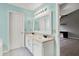 This bathroom features double sinks, cabinets, a vanity, and an entrance door that leads to a bedroom at 12322 Cool Winds W Way, Fishers, IN 46037