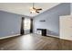 This bedroom features wood floors, light blue walls, a black desk, window with dark curtains and a ceiling fan at 12322 Cool Winds W Way, Fishers, IN 46037