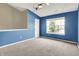 Bedroom with blue walls, ceiling fan and carpeted floor at 12322 Cool Winds W Way, Fishers, IN 46037