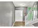 Entryway with gray walls, a white front door with glass insert, and a tiled floor with a staircase on the side at 12322 Cool Winds W Way, Fishers, IN 46037