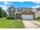 Charming two-story home with a brick and vinyl exterior, a well-manicured lawn, and an attached two-car garage at 12322 Cool Winds W Way, Fishers, IN 46037