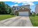 A well-maintained two-story home with a two-car garage, a long driveway and a lush green lawn under a partly cloudy sky at 12322 Cool Winds W Way, Fishers, IN 46037