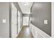 Hallway with neutral paint, base molding and multiple doors at 12322 Cool Winds W Way, Fishers, IN 46037