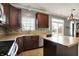 Kitchen with stainless appliances, island and a view of the backyard through sliding glass doors at 12322 Cool Winds W Way, Fishers, IN 46037