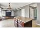 Kitchen island open to a living room with built in shelving at 12322 Cool Winds W Way, Fishers, IN 46037