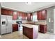 Updated kitchen with stainless steel appliances, kitchen island, and stylish backsplash at 12322 Cool Winds W Way, Fishers, IN 46037