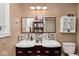 Dual sink bathroom vanity with updated fixtures and ample lighting at 1345 Westwind Dr, Avon, IN 46123