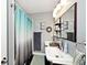 Clean bathroom with double sinks, and a shower with a blue curtain at 1345 Westwind Dr, Avon, IN 46123