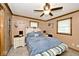 Well-lit bedroom with a queen bed, ceiling fan, and ensuite nightstands at 1345 Westwind Dr, Avon, IN 46123