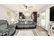 Open living area featuring a comfortable sofa, wood-look flooring, and natural light at 1345 Westwind Dr, Avon, IN 46123