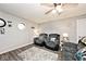 Comfortable living room featuring two plush chairs, ceiling fan, and neutral wall color at 1345 Westwind Dr, Avon, IN 46123