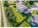 Aerial view showcases a spacious backyard with green lawn, mature trees, and a fence line defining the property at 14109 Secretariat Ct, Carmel, IN 46074