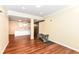 Basement features a half kitchen, exercise equipment and wooden-style floors at 14109 Secretariat Ct, Carmel, IN 46074