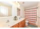 Bathroom with double vanity, framed mirrors, and a gray and orange shower curtain at 14109 Secretariat Ct, Carmel, IN 46074