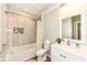 Bathroom with a white vanity, decorative mirror, and neutral shower with decorative accents at 14109 Secretariat Ct, Carmel, IN 46074