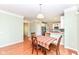 Open dining area leading to the kitchen, complemented by hardwood flooring and ample natural light at 14109 Secretariat Ct, Carmel, IN 46074
