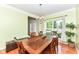 Well-lit dining area with a wooden table, six chairs, and ample natural light from a large window at 14109 Secretariat Ct, Carmel, IN 46074