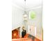 Grand two-story foyer with a chandelier, hardwood floors, and an arched window providing natural light at 14109 Secretariat Ct, Carmel, IN 46074