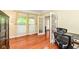 Bright home office featuring hardwood floors, double windows with curtains, and glass paneled doors at 14109 Secretariat Ct, Carmel, IN 46074