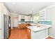 Modern kitchen featuring stainless steel appliances, a central island and light-colored countertops at 14109 Secretariat Ct, Carmel, IN 46074